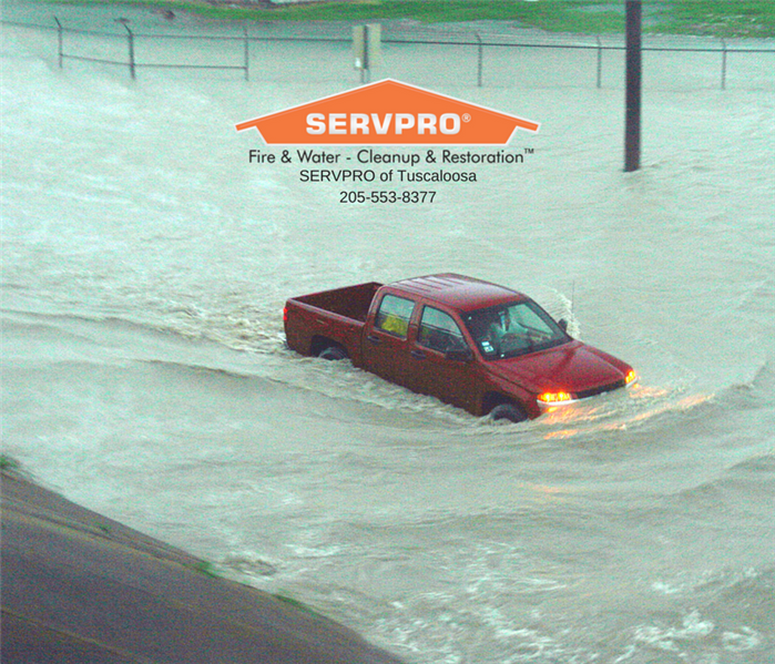 A truck in Northport, AL flooded in the street by an overload of rain water.