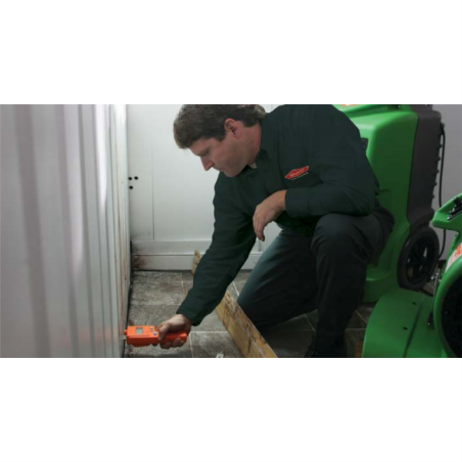 A SERVPRO technician measuring the walls for moisture after a water damage.  