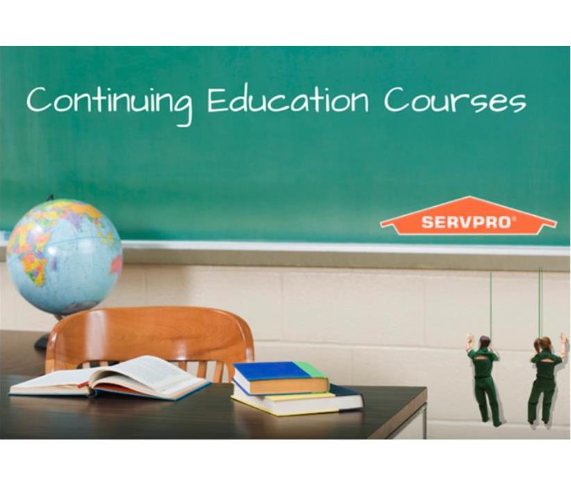 "Continuing Education Courses" is written on a chalkboard in a classroom.